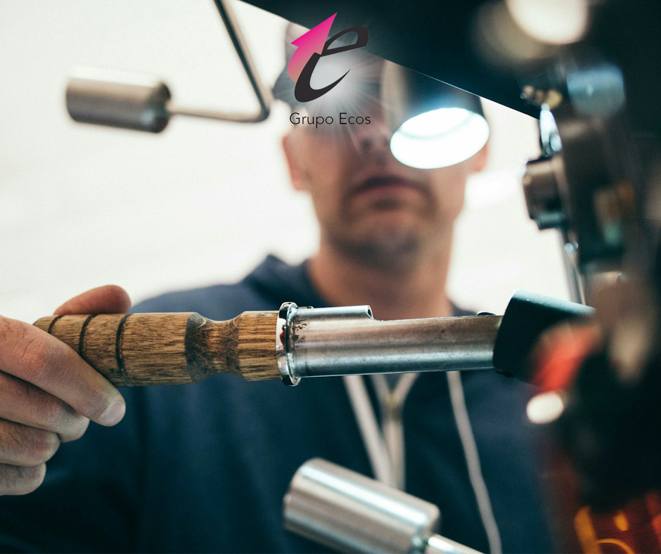 man wearing black pullover hoodie holding tool